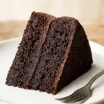 Vegan chocolate cake slice on rustic plate